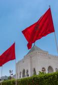 Two Moroccan flags in front of a blue sky