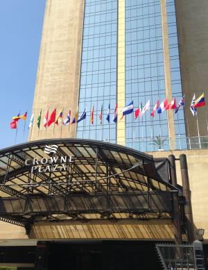 The front awning of the Crowne Plaza Hotel, displaying several national flags