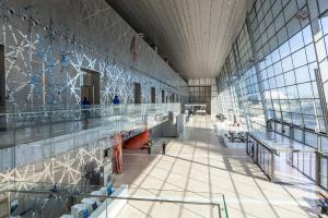 Interior hall of the DECC with light shining through glass wall