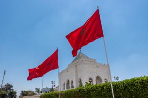 Two Moroccan flags in front of a blue sky