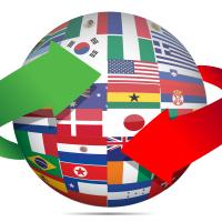 A sphere containing a mosaic of world flags. A red arrow and a green arrow are circling the sphere.