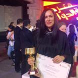 Basema Younes holding her award