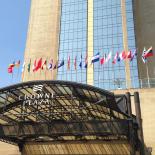 The front awning of the Crowne Plaza Hotel, displaying several national flags