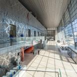 Interior hall of the DECC with light shining through glass wall