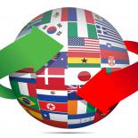 Picture of the globe covered in national flags with arrows to imply spinning