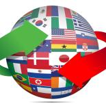 A sphere containing a mosaic of world flags. A red arrow and a green arrow are circling the sphere.