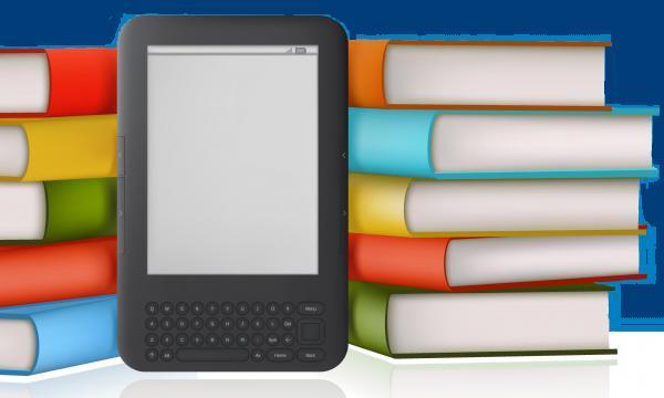 A black ereader with a blank screen in front of a stack of multi-coloured hardback books